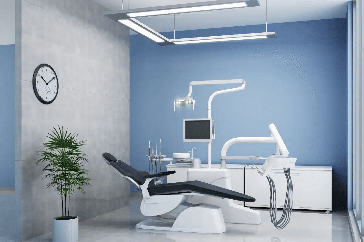 Modern dental treatment room with a blue accent wall and patient chair.