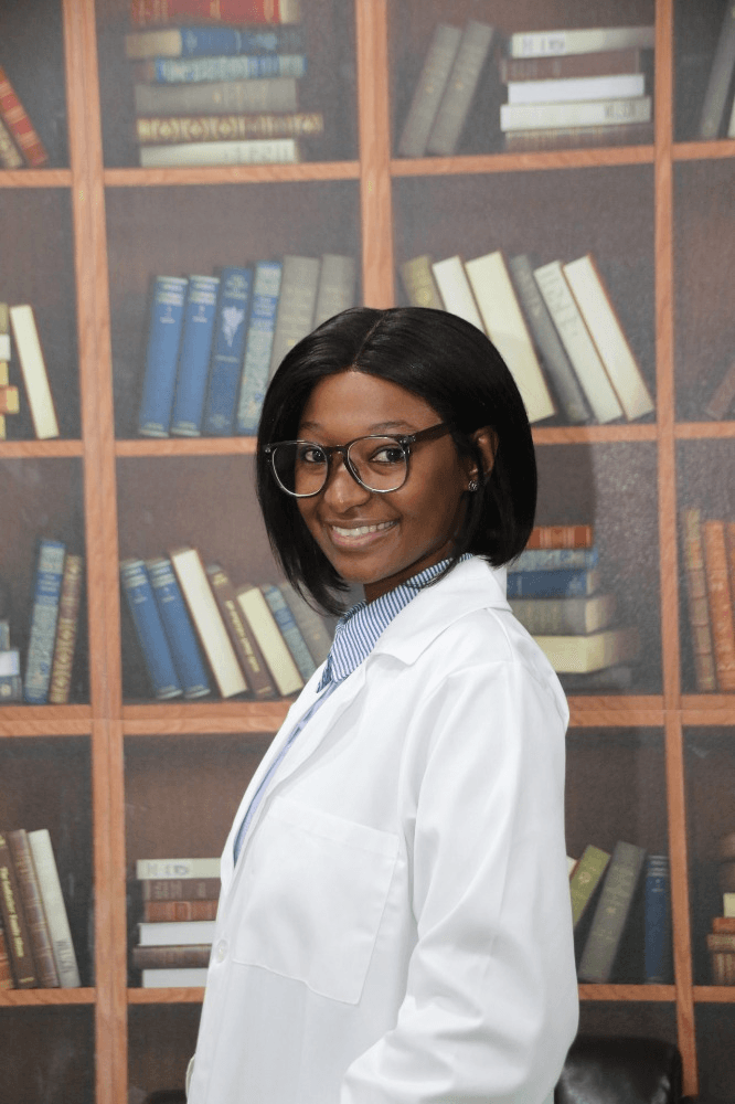 Dr. AK Ngobeni smiling in a white coat.